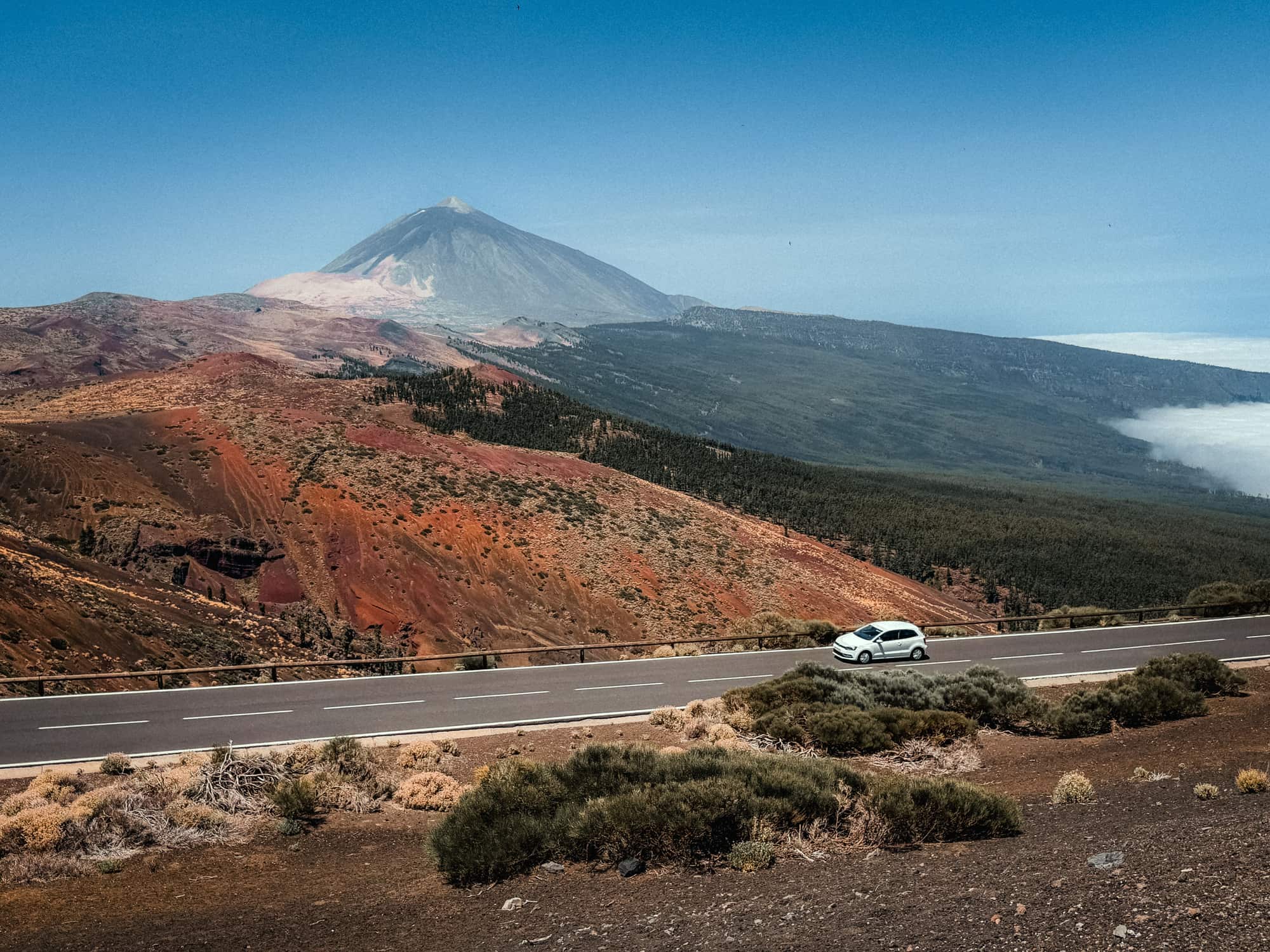 A car on a road below the slopes of Mount Teide